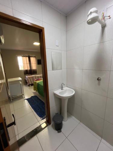 a bathroom with a sink and a shower and a toilet at Pousada do Gil in Iguatu