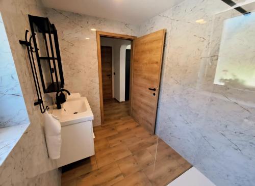a bathroom with a sink and a mirror at Riverside Apartma 1, Kranjska Gora in Kranjska Gora