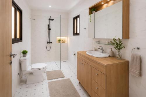 a bathroom with a toilet and a sink and a shower at JONARIC Residence - Luxury Villa in Lomé in Azyagbang