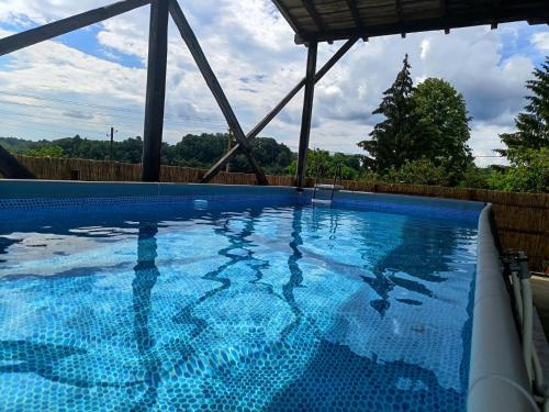 a large swimming pool with blue water at Vila Seoska idila in Izvor