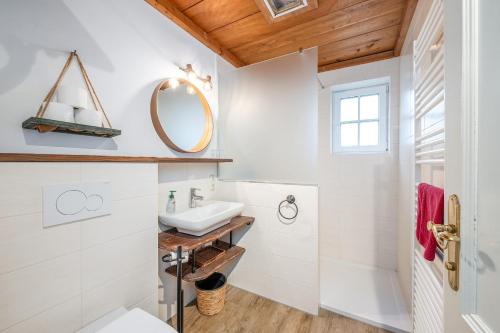 a bathroom with a sink and a mirror at Stanglhof - by myNests in Bad Aussee