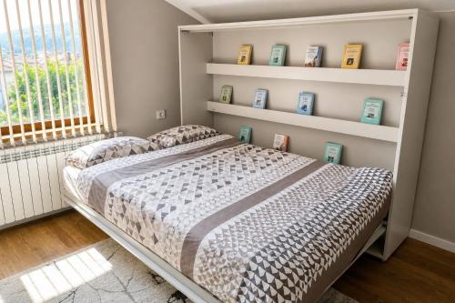 a bedroom with a bed in a room with a window at Mountain View Apartment in Troyan