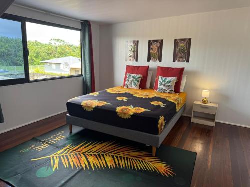 a bedroom with a bed and a large window at La Maison Blanche, 2 bedrooms in Macouria