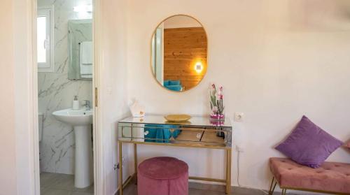 a bathroom with a sink and a mirror at Divine Studios A1 in Elafonisos