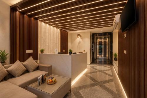 a living room with a couch and a table at Hotel Vibe BLU & Banquet Near Advant, Embassy Oxygen & Sector 142,143 Metro, Noida in Noida