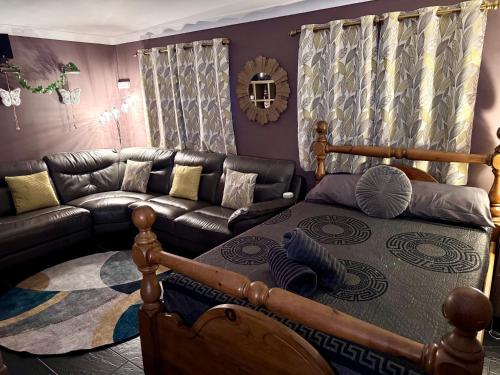 a living room with a bed and a couch at Pentre Country Studio in Wrexham