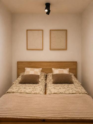 a bedroom with a bed with two pillows on it at Apartament 3 Maja in Brodnica
