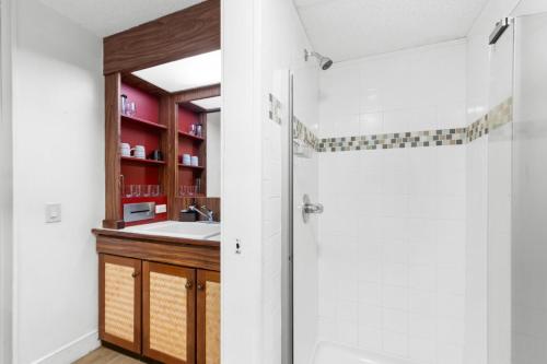 a bathroom with a sink and a shower at Kona Islander Inn#228: Located in downtown Kona! in Kailua-Kona