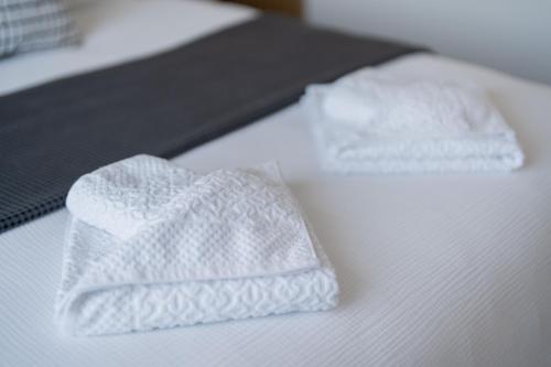 two white towels sitting on top of a bed at Apartman Nika-Self check-in,Free Parking in Vukovar