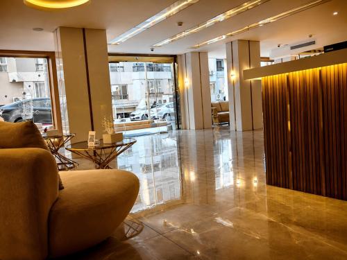 a lobby with a couch and tables in a building at Flamingo Cairo Airport Hotel & Free Airport Pickup in Cairo