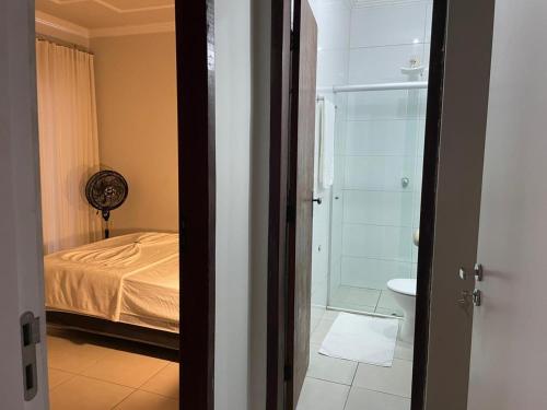 a bedroom with a bed and a shower and a toilet at Dali Apart hotel in Ipatinga