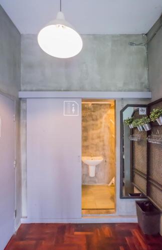 a bathroom with a sink in the middle of a room at Atlas Bangkok Hotel in Bangkok