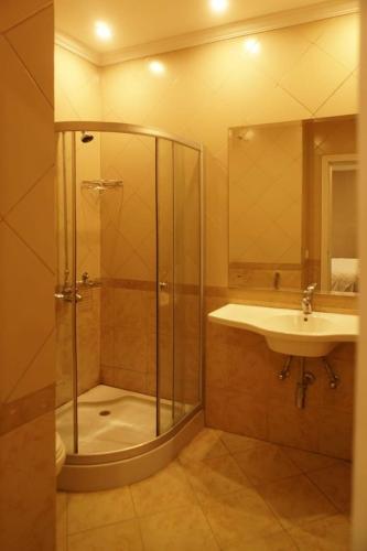 a bathroom with a shower and a sink at Wisteria Cottage in Dunga Gali