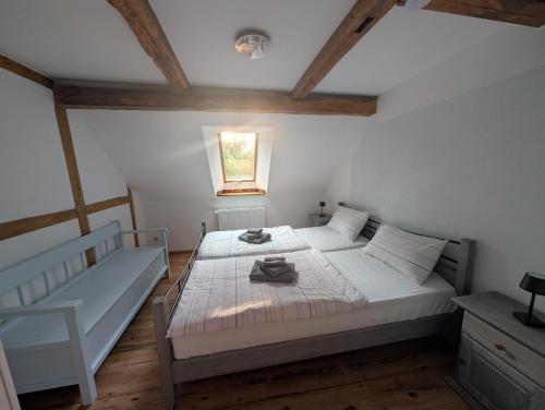 a bedroom with a white bed and a window at Zum altem Forsthof Grittel in Grittel