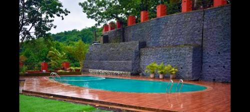 a swimming pool in the middle of a yard at LODHA VINTAGE Atdc in Kolvan