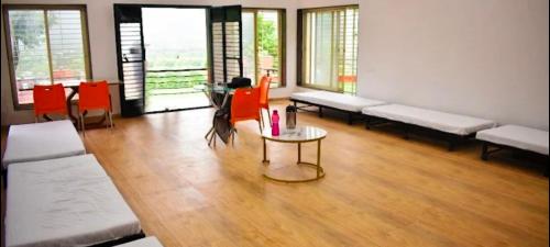a room with benches and a table and chairs at LODHA VINTAGE Atdc in Kolvan
