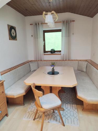 a dining room with a table and a bench at Haus Enzian in Mittersill