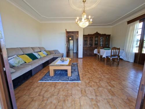 a living room with a couch and a table at Sitio dos Machados in Póvoa de Lanhoso