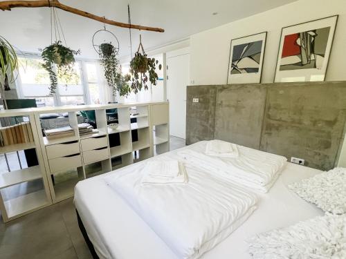 a bedroom with a large white bed in it at Studio Margriet in Bergen