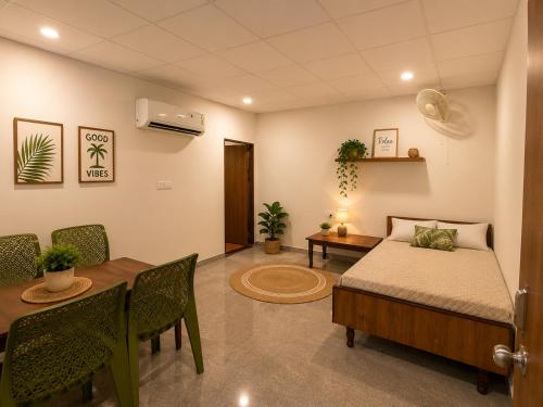 a room with a bed and a table and a dining room at Aanadam Resort in Jaipur