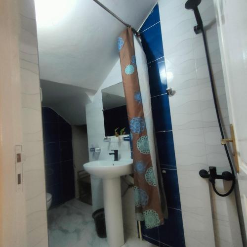 a bathroom with a sink and a shower at Appart Dakhla Cool in Dakhla