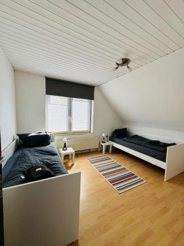 a bedroom with two beds in a attic at CityStay House 42 in Bremerhaven