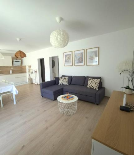a living room with a couch and a table at Rina Apartment- with barbecue and free parking in Kaštela