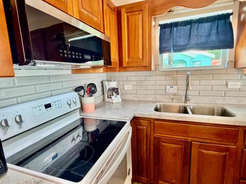 a kitchen with a stove and a sink at Sunset Beach Resort in San Pedro