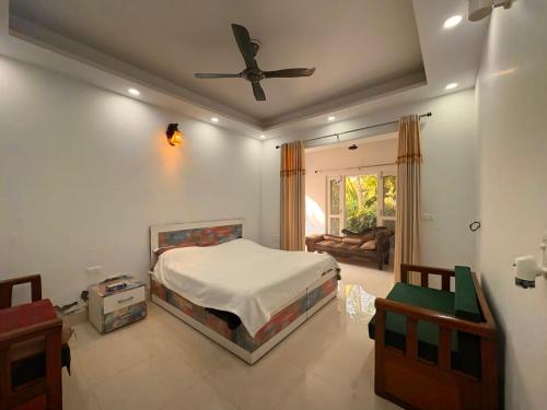 a bedroom with a bed and a ceiling fan at Golden Villas in Rewāri