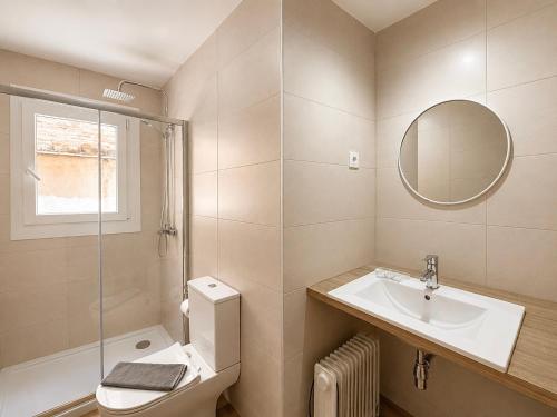 a bathroom with a sink and a toilet and a mirror at CozyCatalonia - Exclusive Attic in Central Blanes in Blanes
