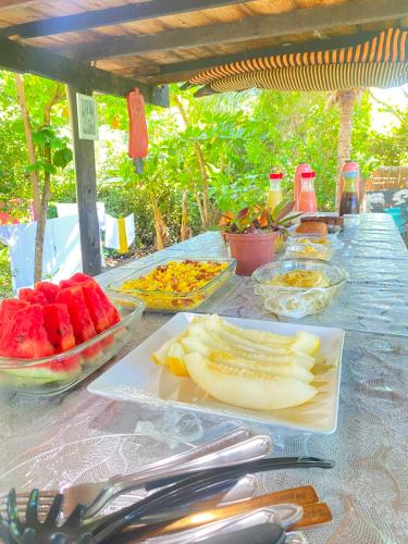 a table topped with bowls of fruit and vegetables at Cabana Jamelão in Camaçari