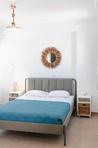 a bedroom with a bed with a mirror on the wall at Orion Sea View Studio in Parasporos