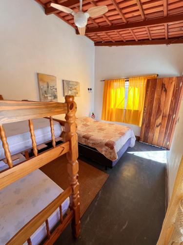 a bedroom with two bunk beds and a window at Chácara buriti in Pirenópolis