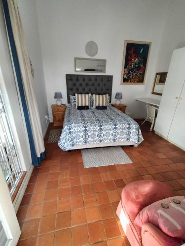 a bedroom with a bed and a table and a couch at Ocean Walk Starfish in Zinkwazi Beach