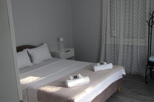 a bedroom with a bed with two towels on it at Villa Martar in Mostar