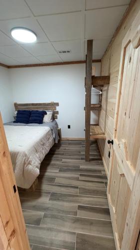a bedroom with a bed with blue pillows on it at cozy corner in Dalton