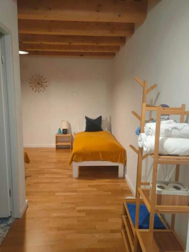a bedroom with a bed with a yellow blanket at WERK 2 - B&B Ecoturistic - Saschiz in Saschiz
