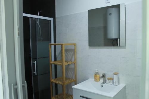 a bathroom with a white sink and a mirror at Royal Racing Suite Top 2 near Red Bull Ring in Judenburg
