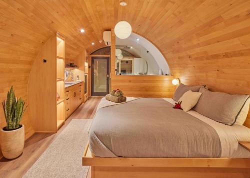 a bedroom with a large bed in a wooden room at ~* The Spectacular Spyglass Treehouse *~ in Occidental