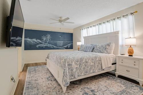a bedroom with a bed and a ceiling fan at 3BR Pool Villa on Golf Course Huge Yard & Games in Wellington