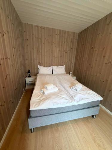 a bedroom with a bed with two towels on it at Finnvika Panorama Corner in Vestvågøya
