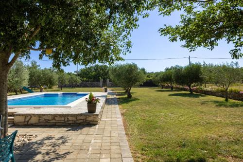 a garden with a swimming pool and a yard with trees at My Dalmatia - Villa Mandorla with private pool and Jacuzzi in Zadar