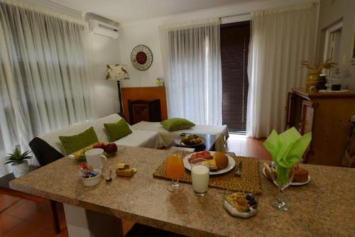 a living room with a table with food on it at Carters Rest Guesthouse in Kimberley
