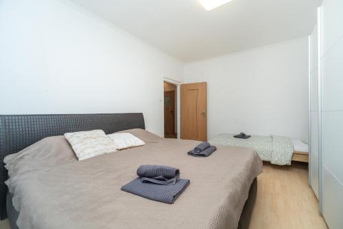 a bedroom with a bed with two towels on it at Nesporova Apartment in Košice