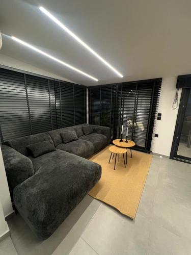 a living room with a large couch and a table at BK Apartment in Xanthi