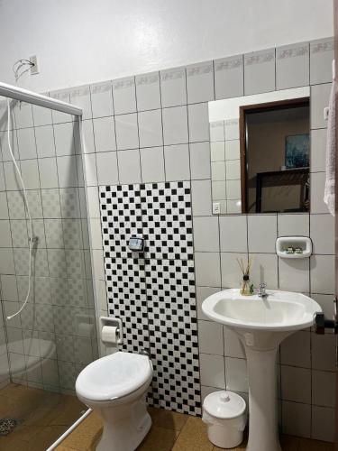 a bathroom with a sink and a toilet and a shower at Camping e Hostel Internacional in Foz do Iguaçu