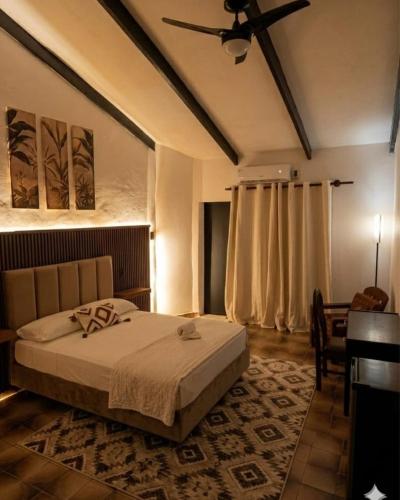 a bedroom with a bed and a ceiling fan at Sarao in Santa Cruz de la Sierra