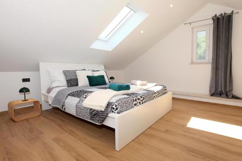 a bedroom with a bed and a skylight at Old town Bol apartments in Bol