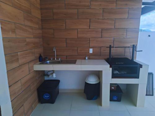 a kitchen with a sink and two trash cans at Nuevos departamentos en Valle de Bravo in Valle de Bravo