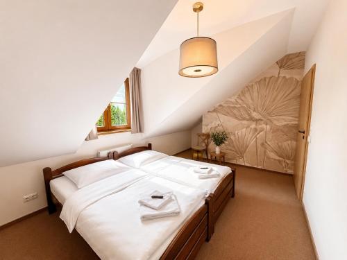 a bedroom with a large bed in a attic at Pod Kolumnami in Pilica